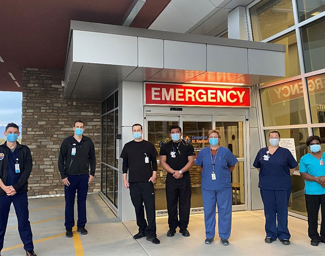 Emergency care team standing outside entrance